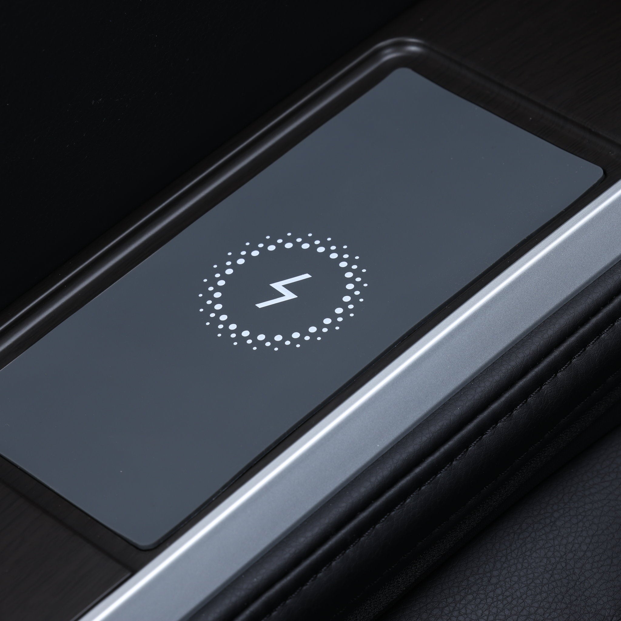 Osaki One Pro 4D massage chair in black — close-up of the wireless phone charging pad