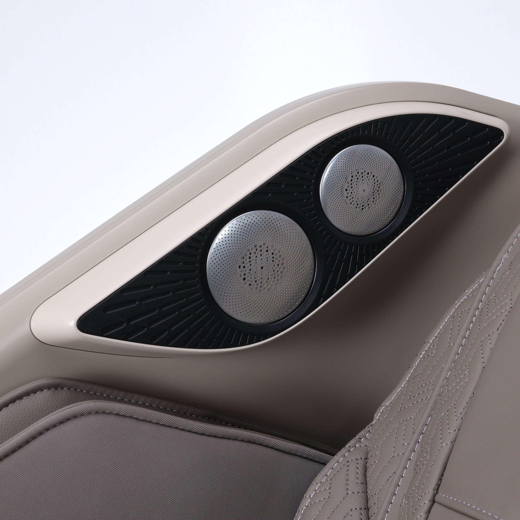 Osaki One Pro 4D massage chair in taupe — close-up of the built-in Bluetooth speakers